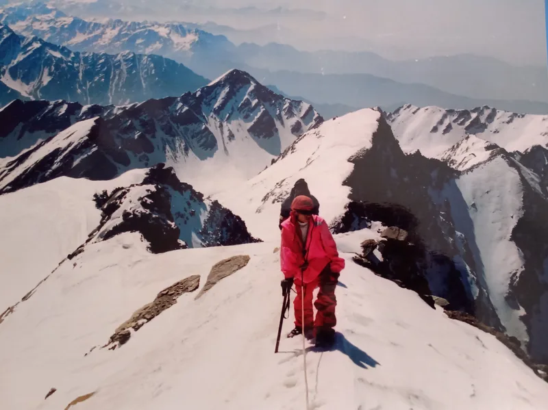Archival photo of an early ICE expedition member on a snow ridge