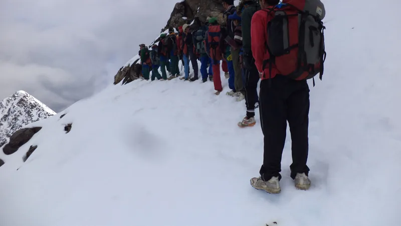 Trekkers walking through a snowy Darma valley